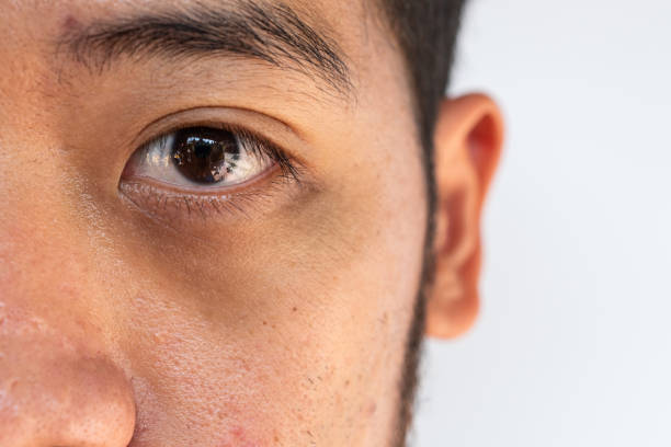 Close-up of young man's eye showing detail and reflection